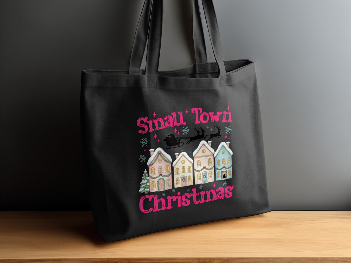 Black tote bag with "Small Town Christmas" design featuring houses, Santa, and reindeer.
