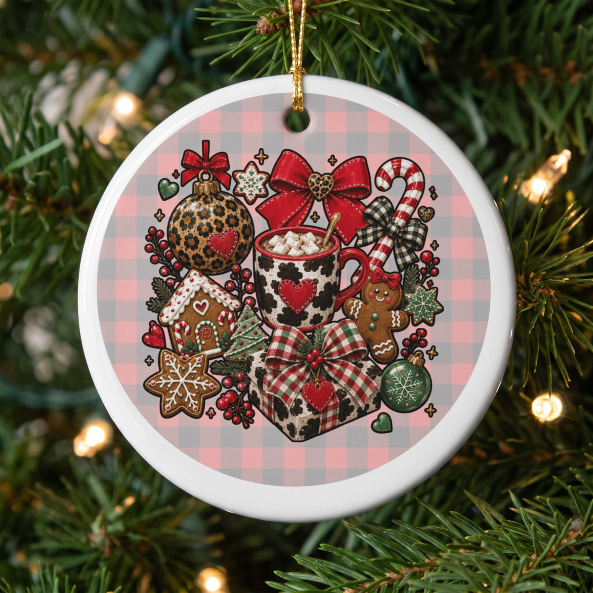 Round Christmas ornament with festive holiday treats, hot cocoa, and bows on plaid background.