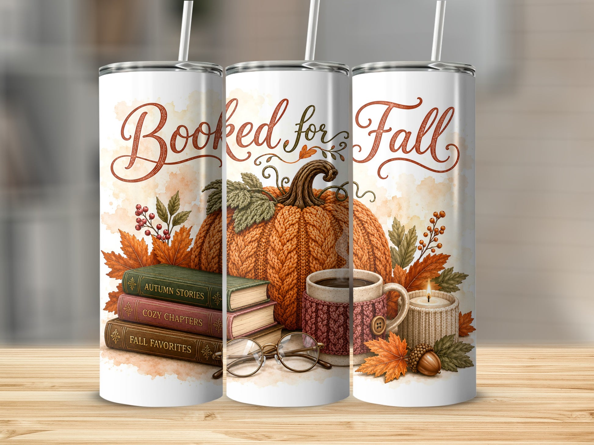 Three tumblers with "Booked for Fall" text, pumpkin, books, mug, and candle.