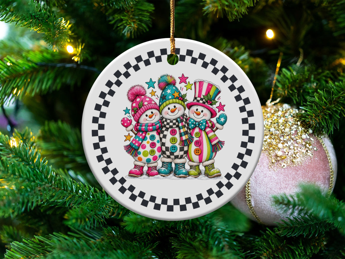 Round ornament with three cartoon snowmen wearing colorful hats and scarves.