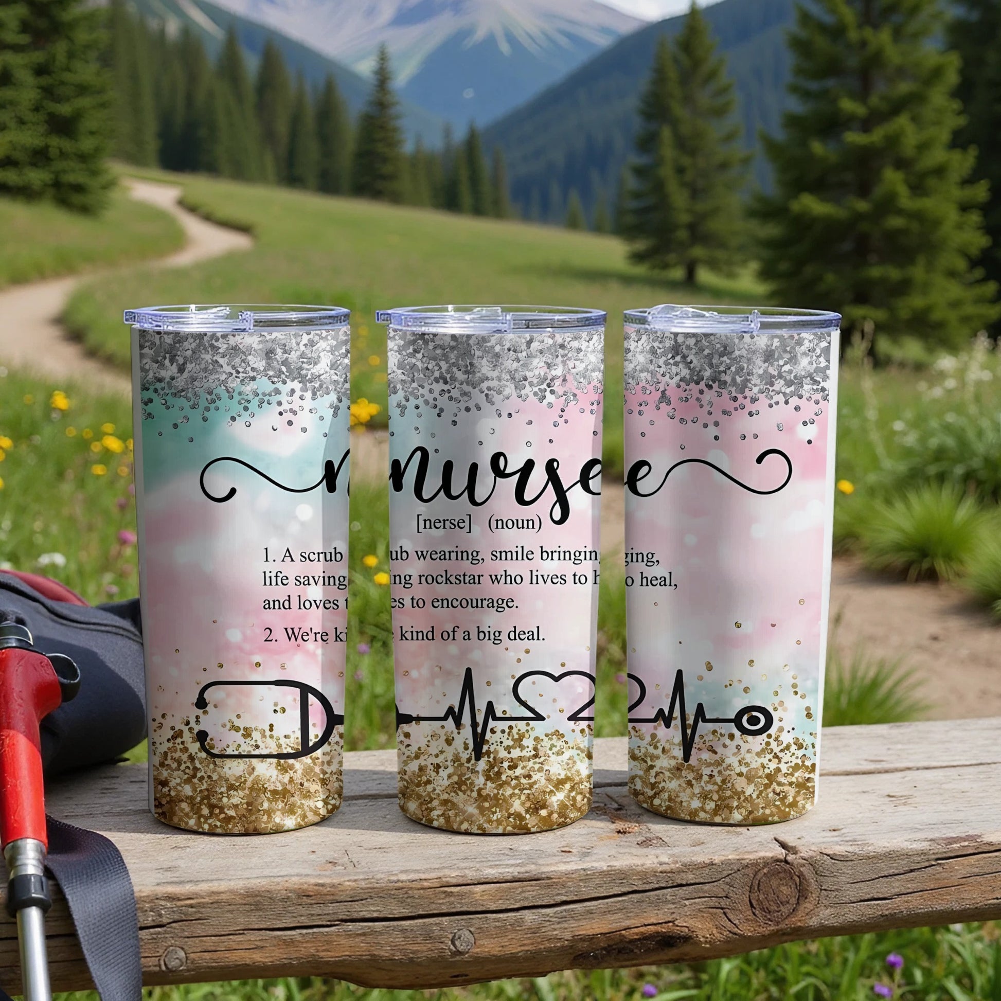 Three tumblers with "nursee" text and inspirational nursing quotes on a wooden surface.