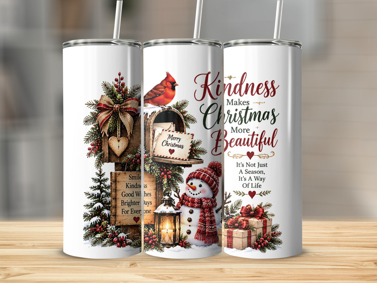 Three white stainless steel tumblers stand upright on a wooden surface, each displaying a different section of a festive holiday illustration featuring a mailbox, a cardinal, a snowman, and Christmas text.