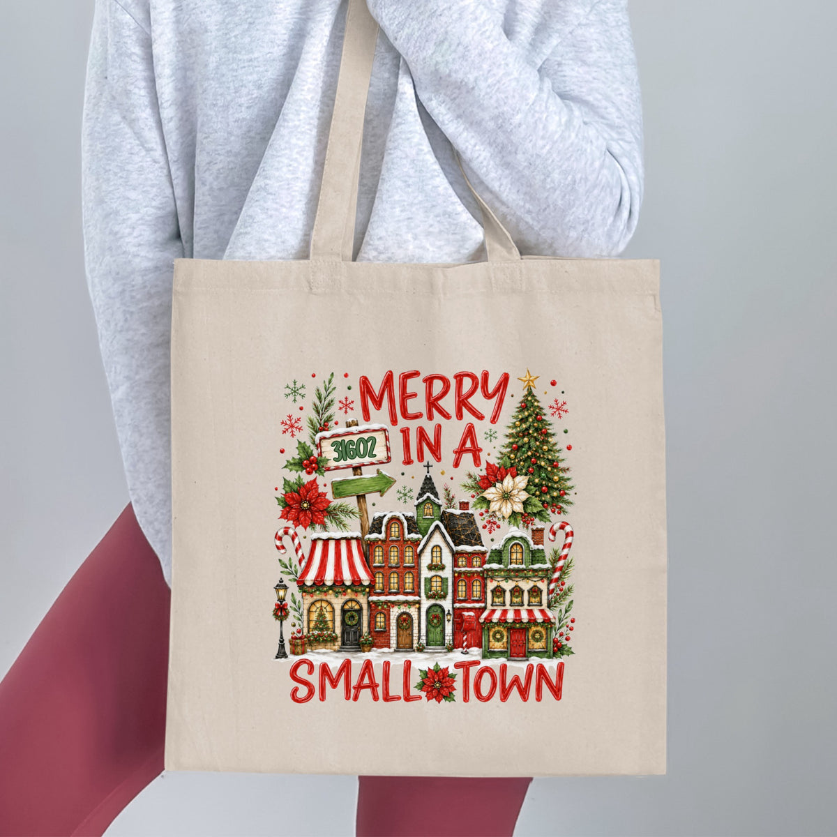 Canvas tote bag with "Merry in a Small Town" Christmas design.