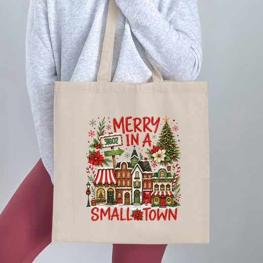 Canvas tote bag with "Merry in a Small Town" Christmas design.