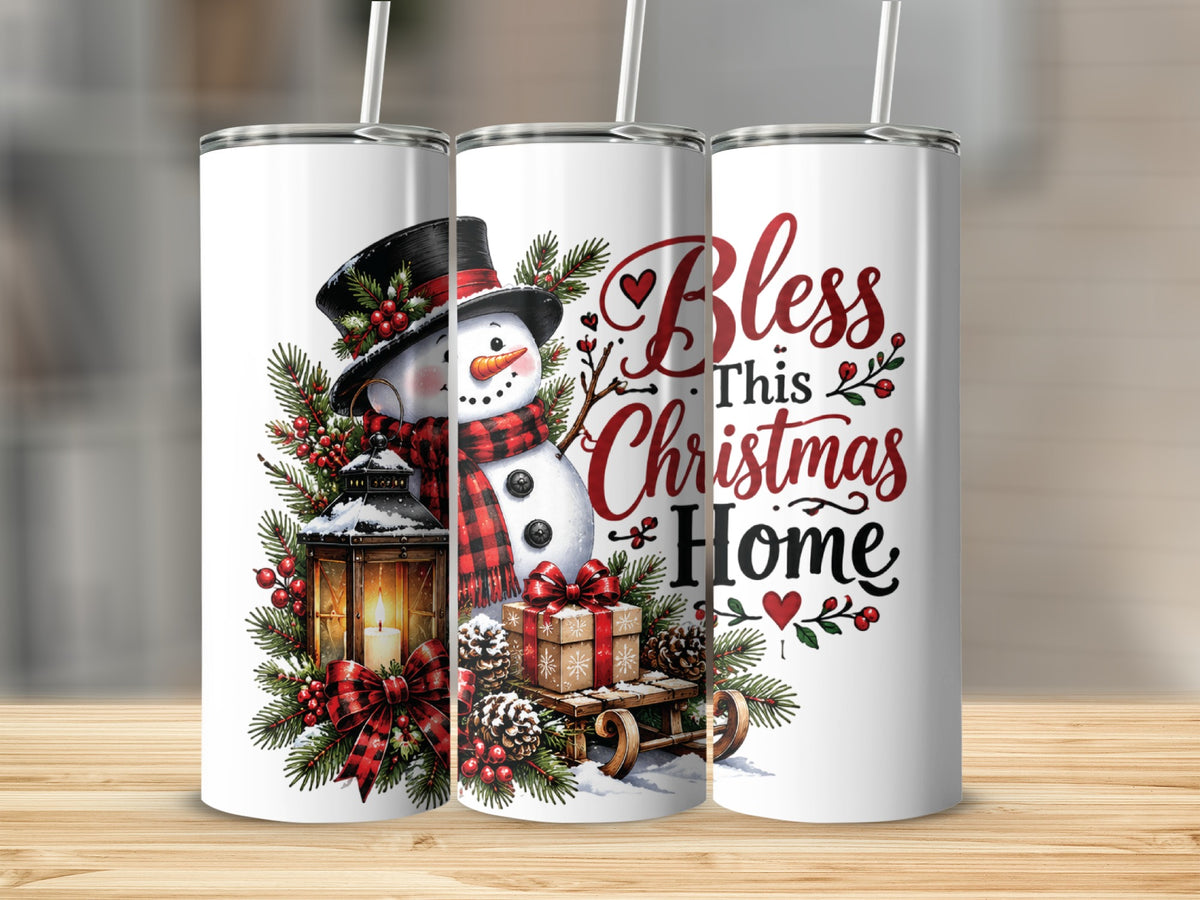 Three white tumblers with straws display a Christmas design featuring a snowman, lantern, wrapped gift, and the text Bless This Christmas Home.