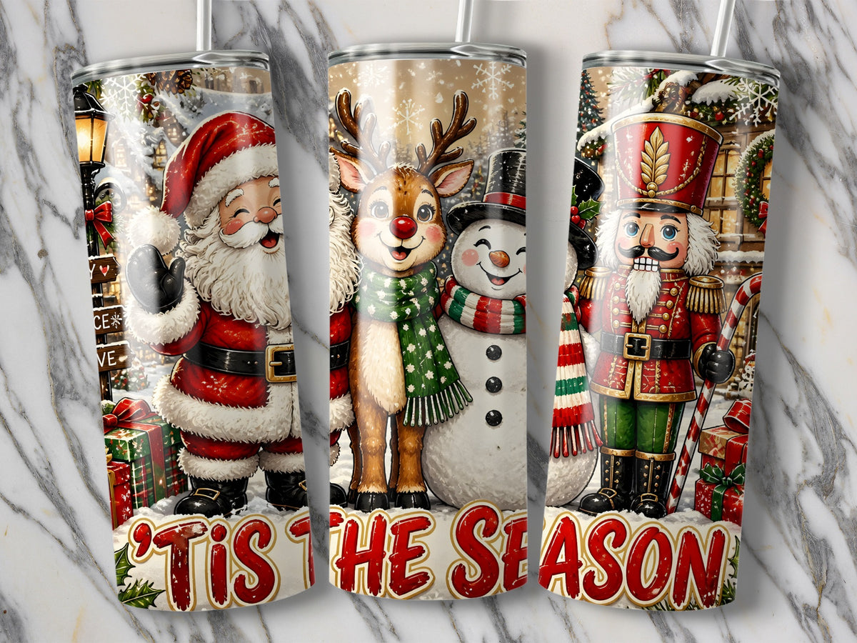 Three metal tumblers display Christmas scenes featuring Santa, a reindeer, a snowman, and a nutcracker with the text 'Tis The Season.