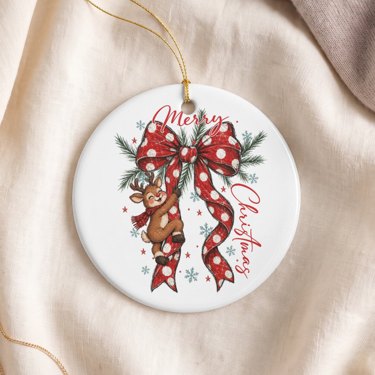 Round ornament with reindeer climbing a polka dot ribbon and "Merry Christmas" text.