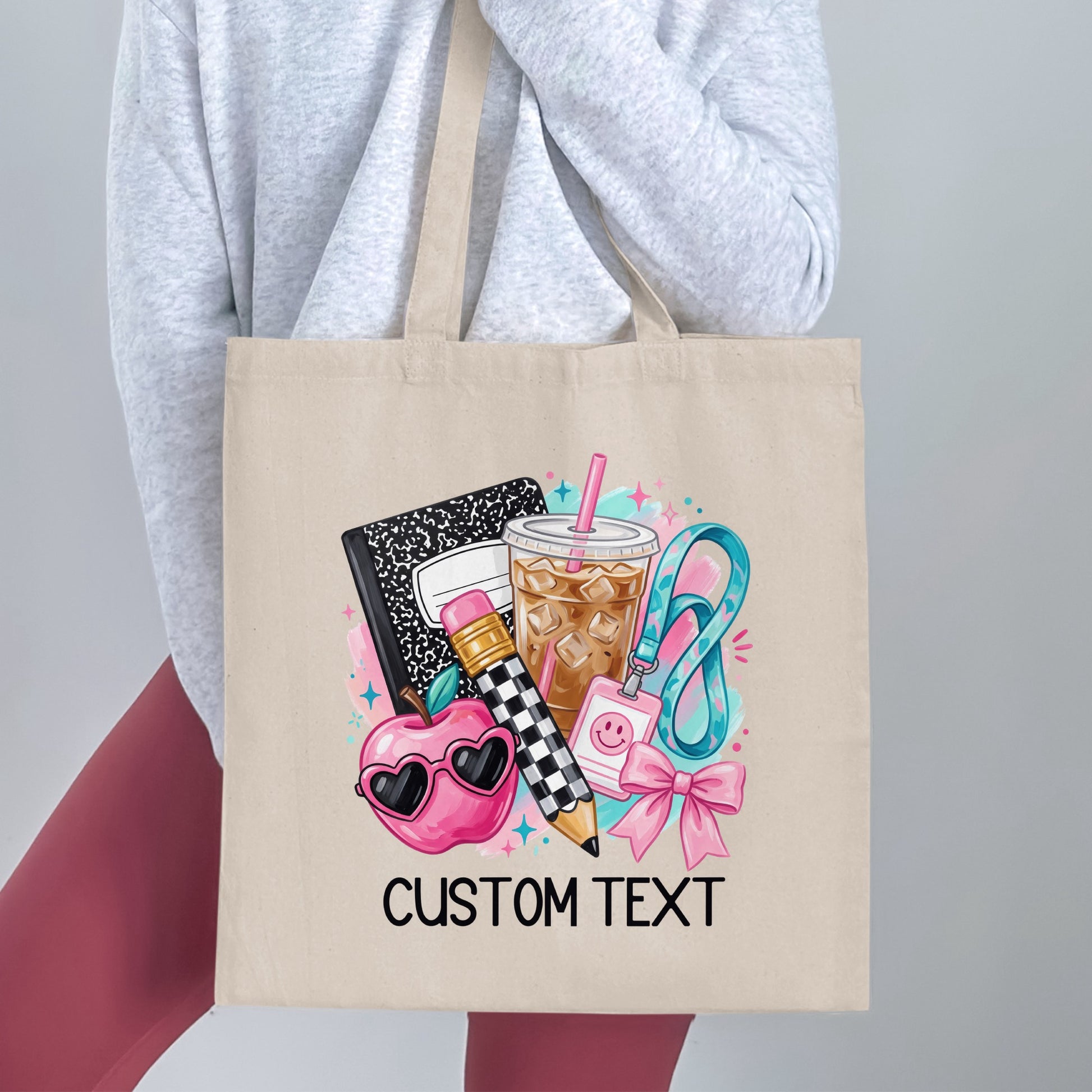 Tote bag with school supplies graphic and "CUSTOM TEXT" at bottom.