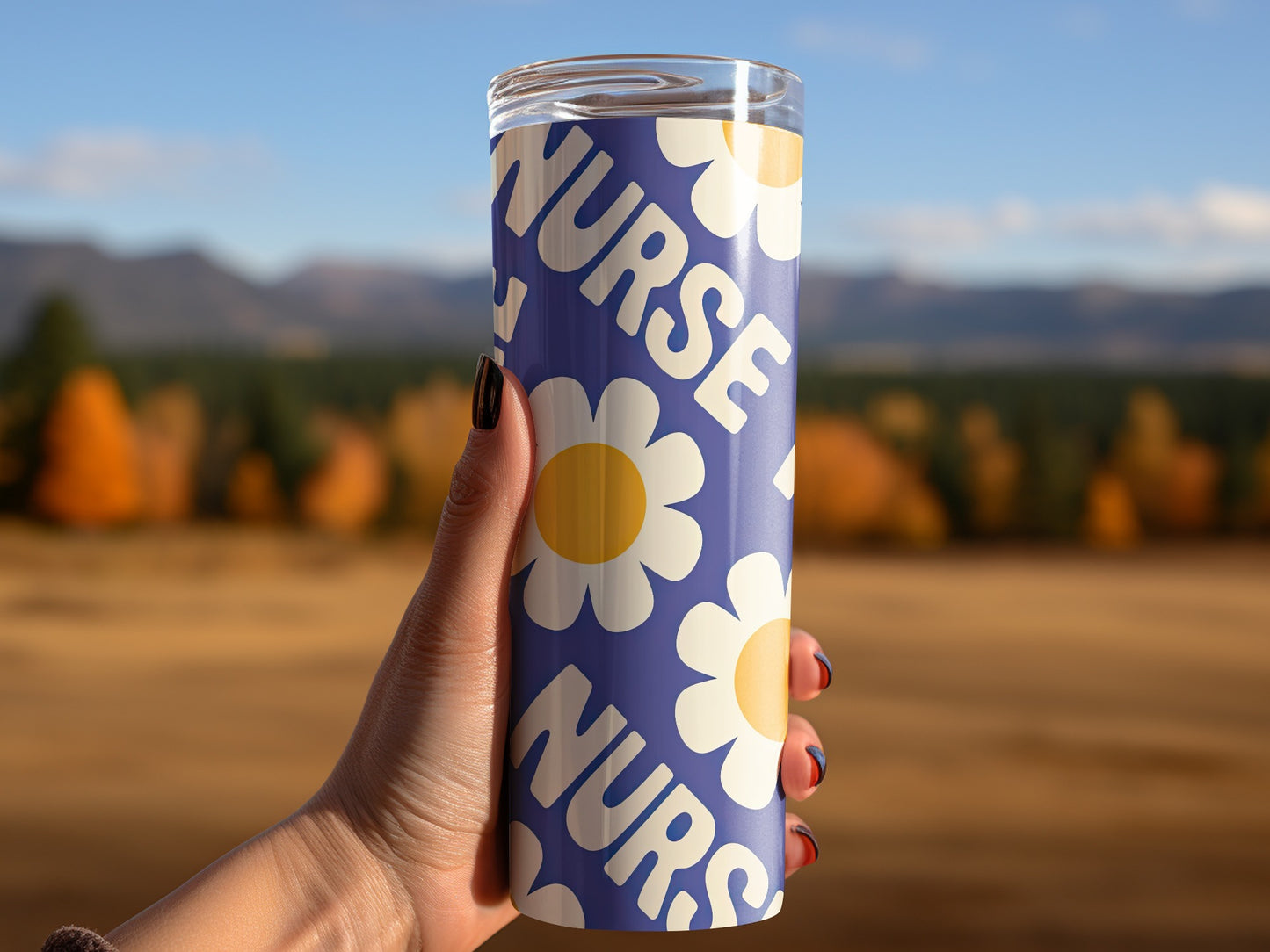 Tumbler with "Nurse" text and floral pattern held by a hand.