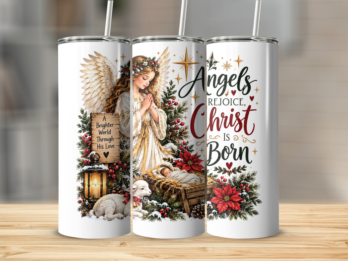 Three slim metal tumblers display a Christmas nativity scene featuring an angel, a manger, and text reading Angels Rejoice, Christ Is Born.