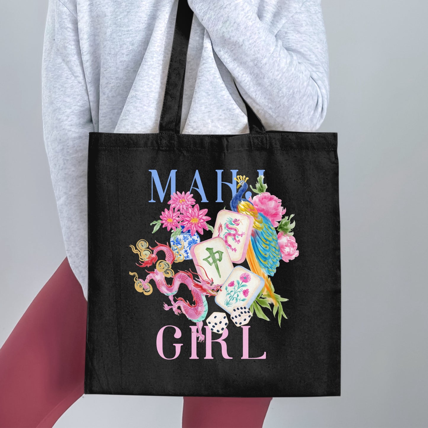 Black tote bag with "MAH GIRL" text and watercolor peacock, dragons, flowers, and mahjong tiles.