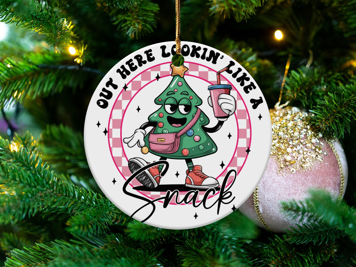 Christmas tree ornament with cartoon tree saying "Out Here Lookin' Like a Snack".