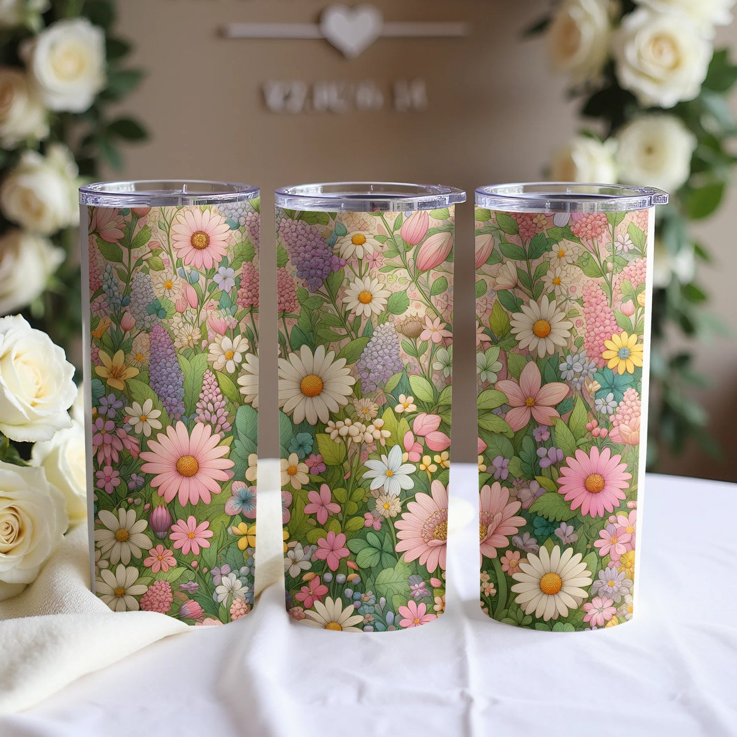 Three tumblers with floral patterns in soft pinks, yellows, and purples.