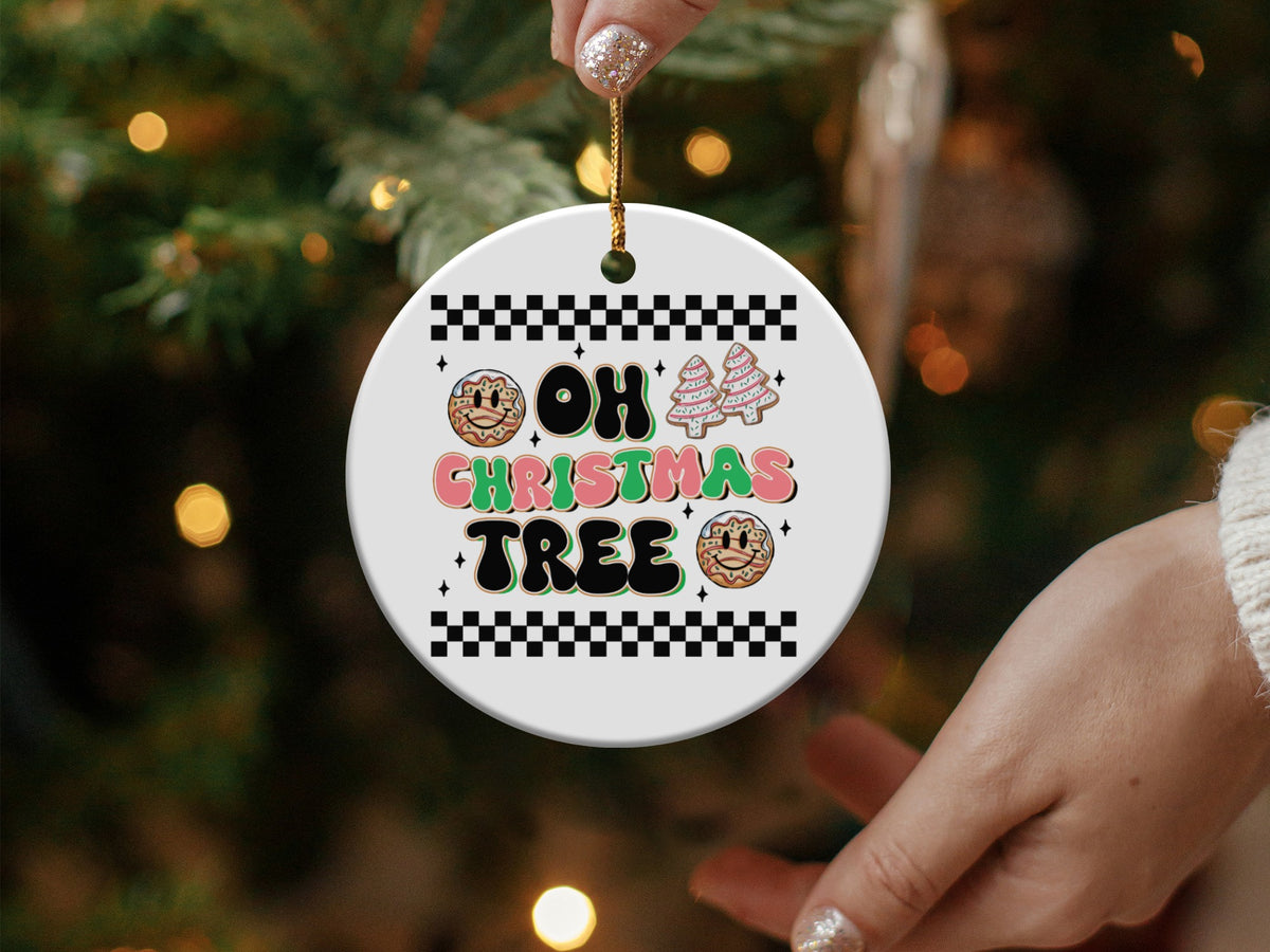 Round ceramic ornament with "Oh Christmas Tree" text and festive graphics.