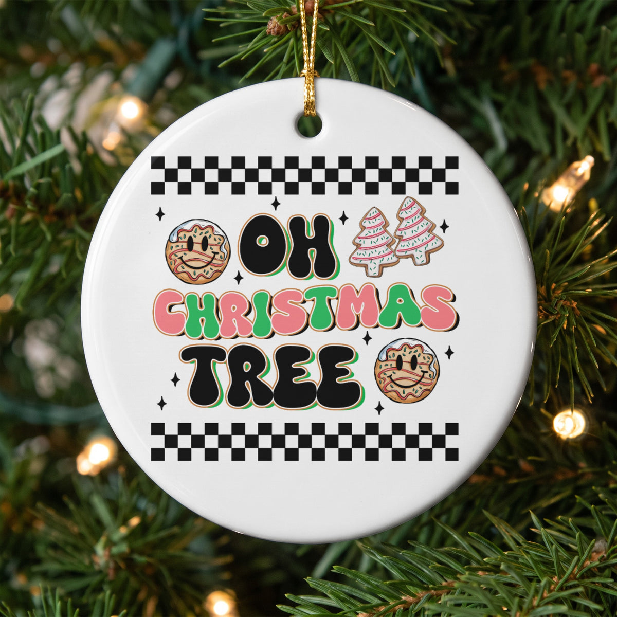 "Oh Christmas Tree" text on a round ornament with smiley donuts and gingerbread trees.