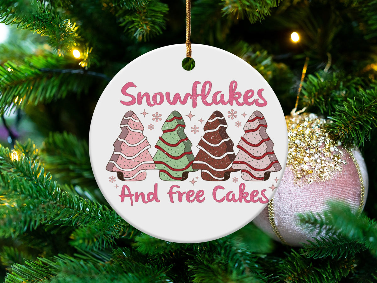 Round ornament with text "Snowflakes And free Cakes" and four decorated gingerbread trees.