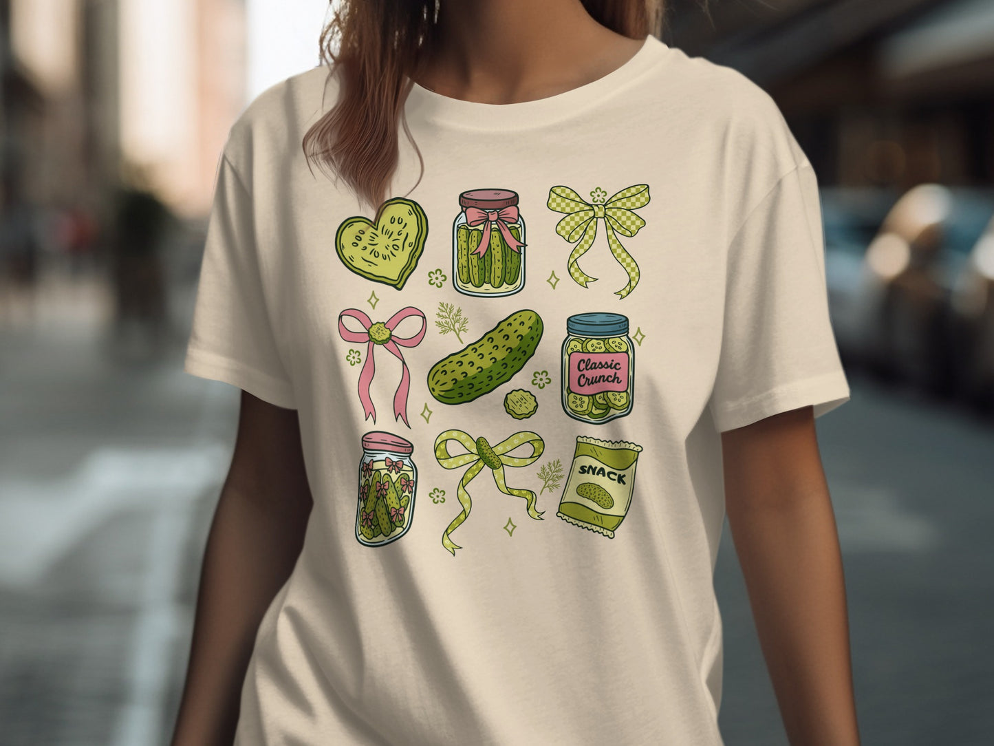 Assortment of pickles in jars, hearts, and a snack bag, with bows.