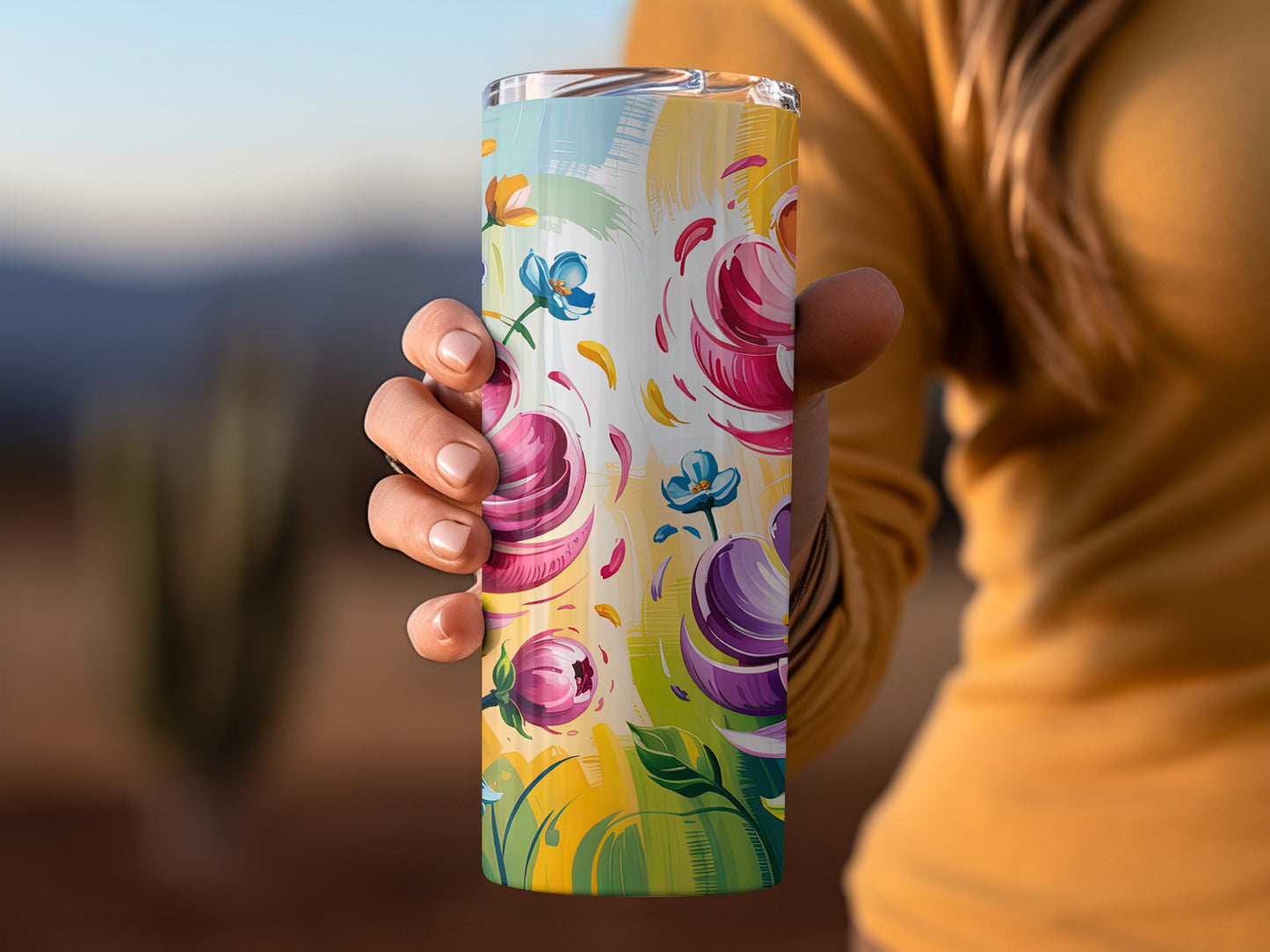 Tumbler with abstract floral design in pink, blue, and yellow.