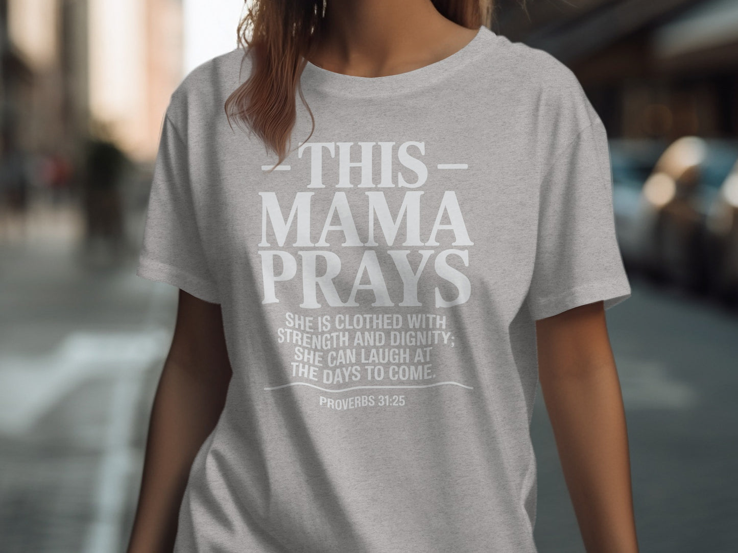 Gray t-shirt with text "THIS MAMA PRAYS" and Proverbs 31:25.
