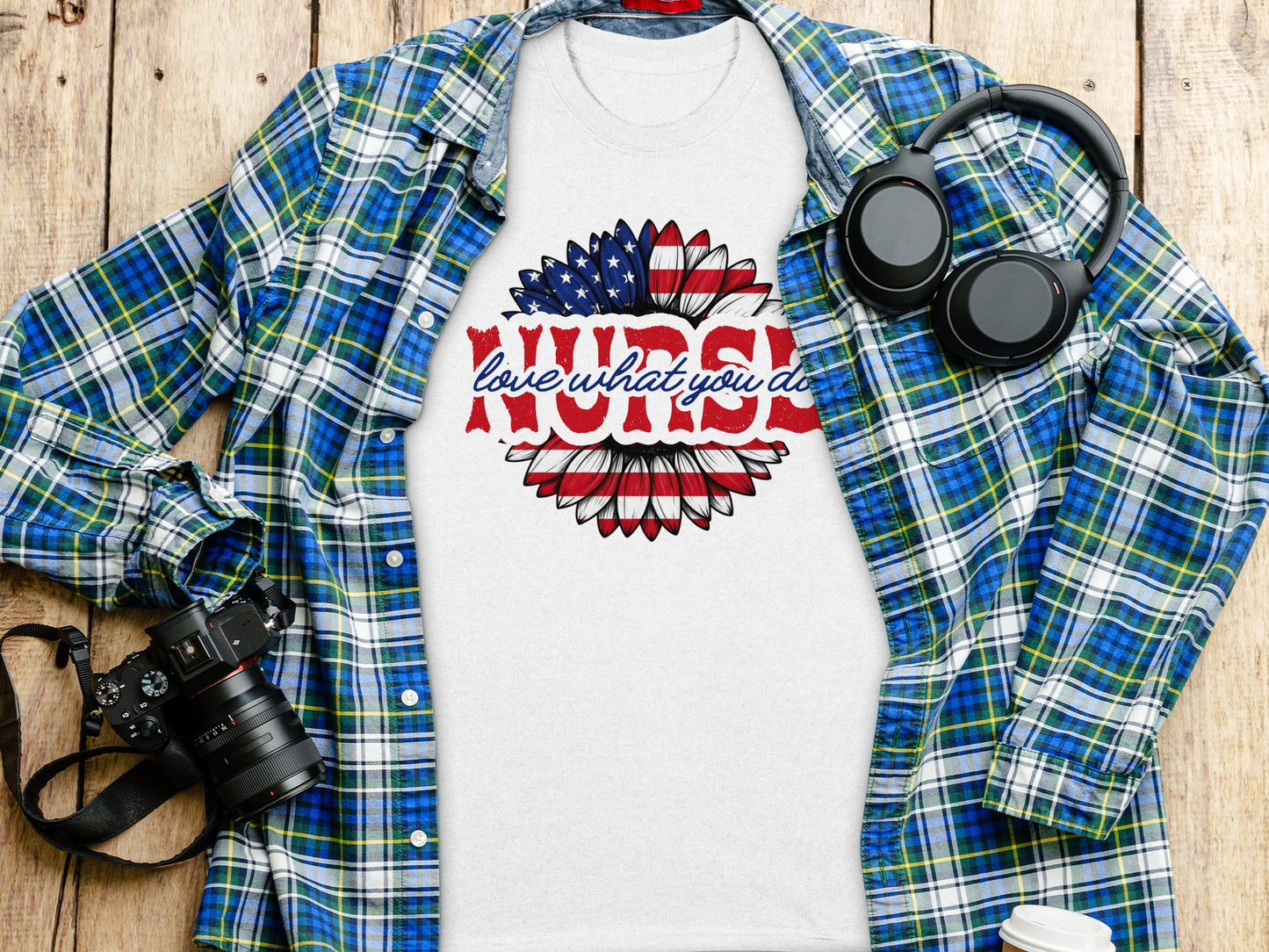 White t-shirt with "love what you do" sunflower design and plaid shirt.