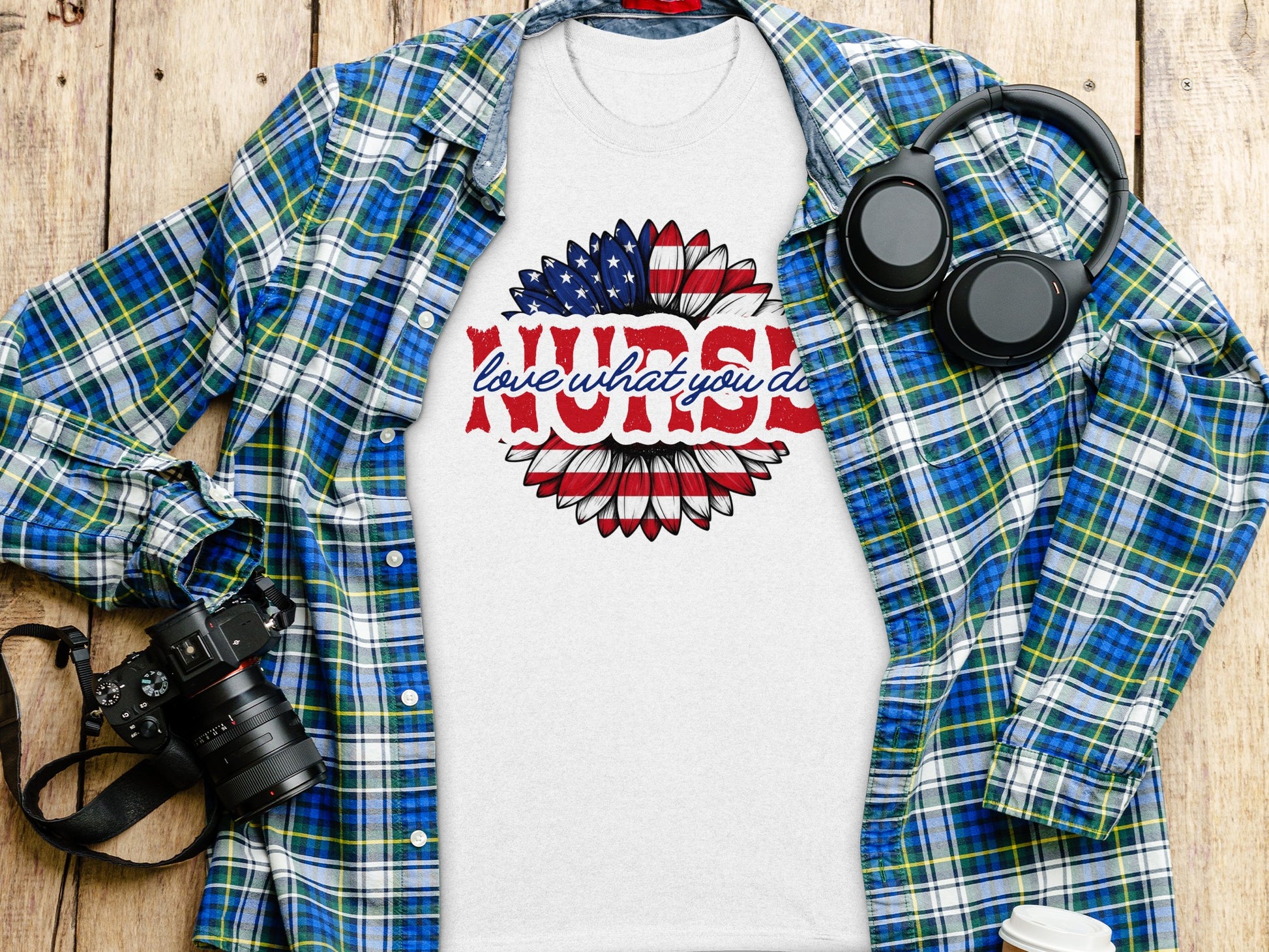 White t-shirt with "love what you do" sunflower design and plaid shirt.