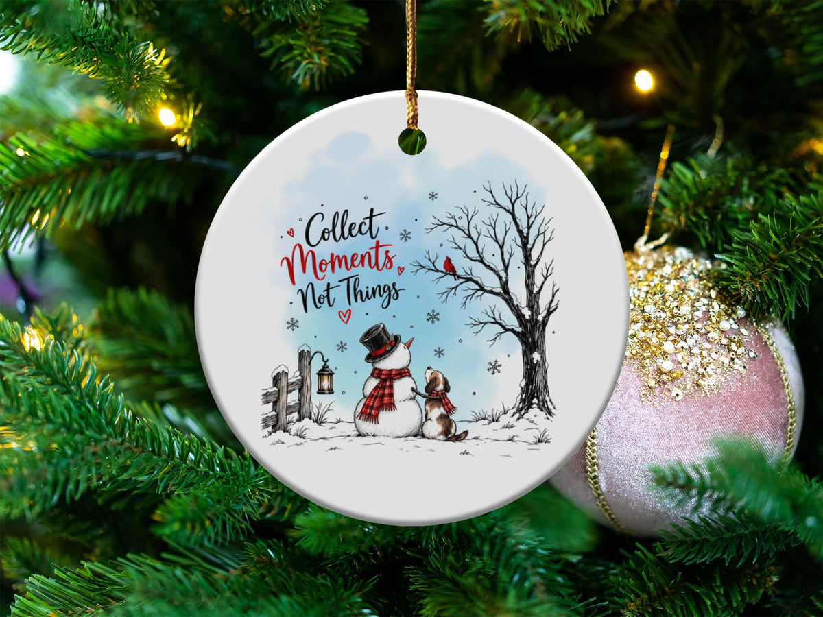 Round white ceramic Christmas ornament featuring a snowman, puppy, and the text Collect Moments Not Things.
