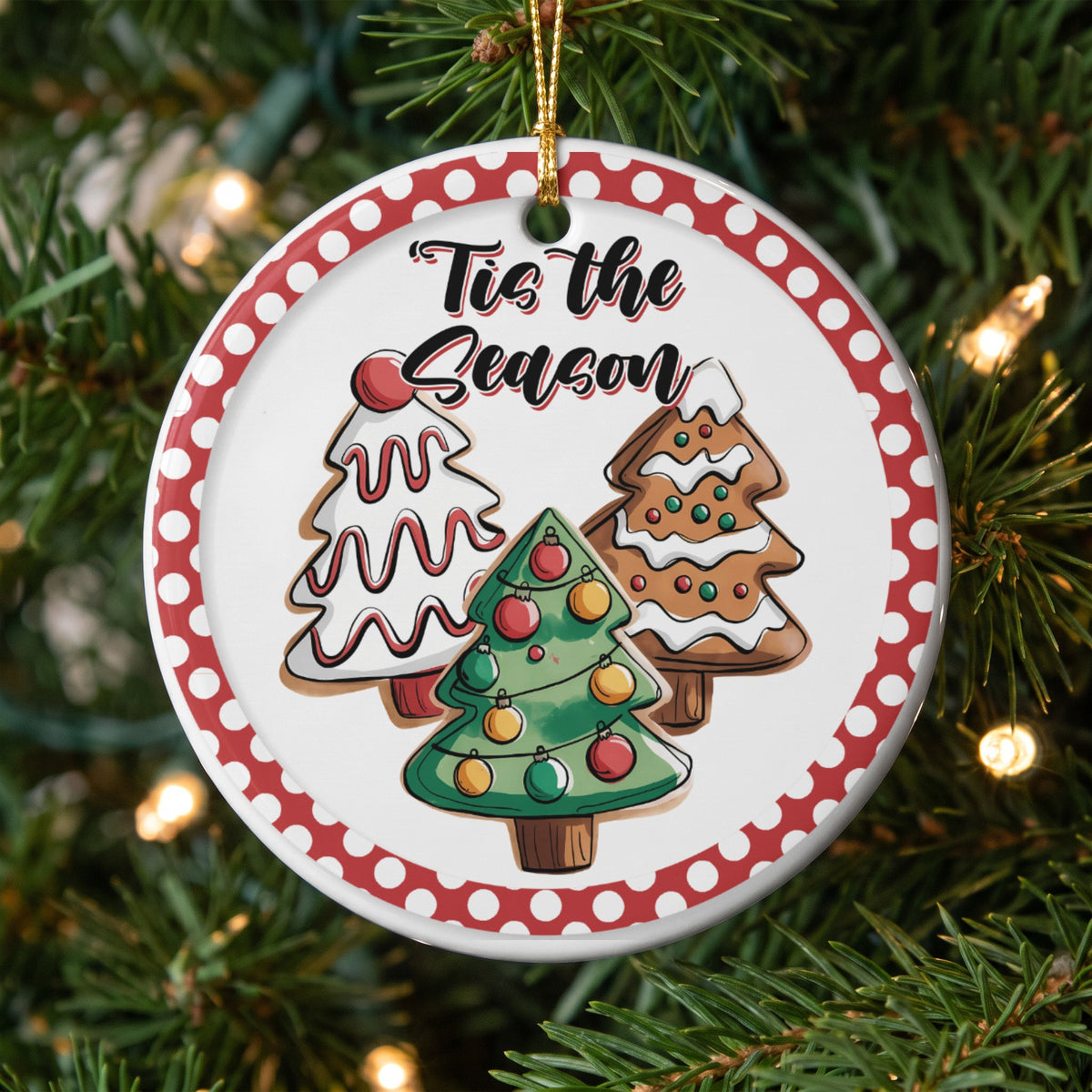 Christmas ornament with gingerbread and frosted trees and text "Tis the Season".