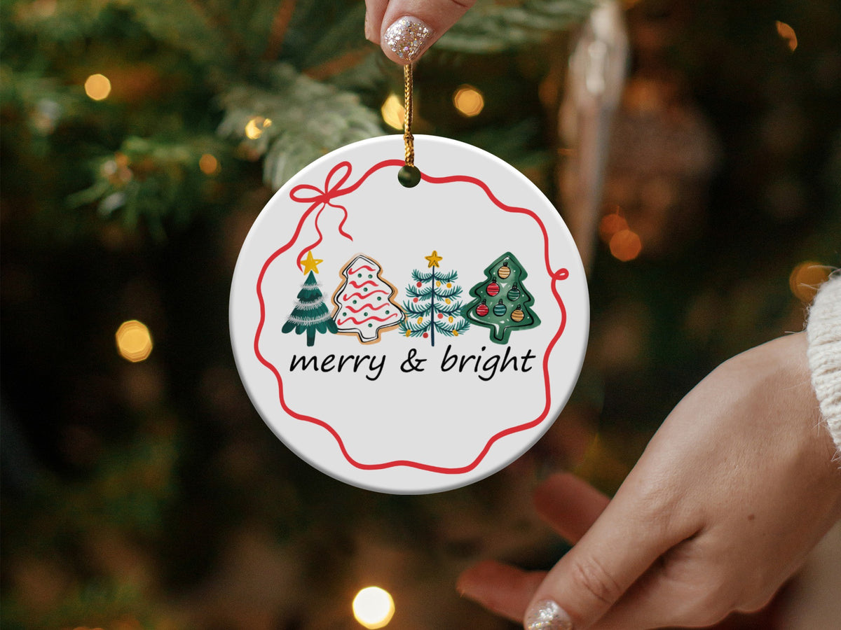 Round Christmas ornament with trees and cookies, says "merry & bright".