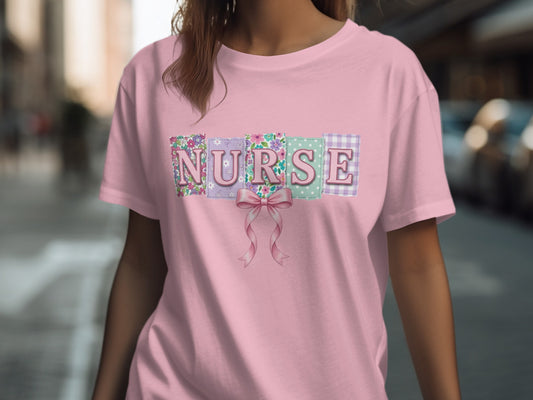 Pink t-shirt with "NURSE" in floral and gingham patchwork and a pink bow.