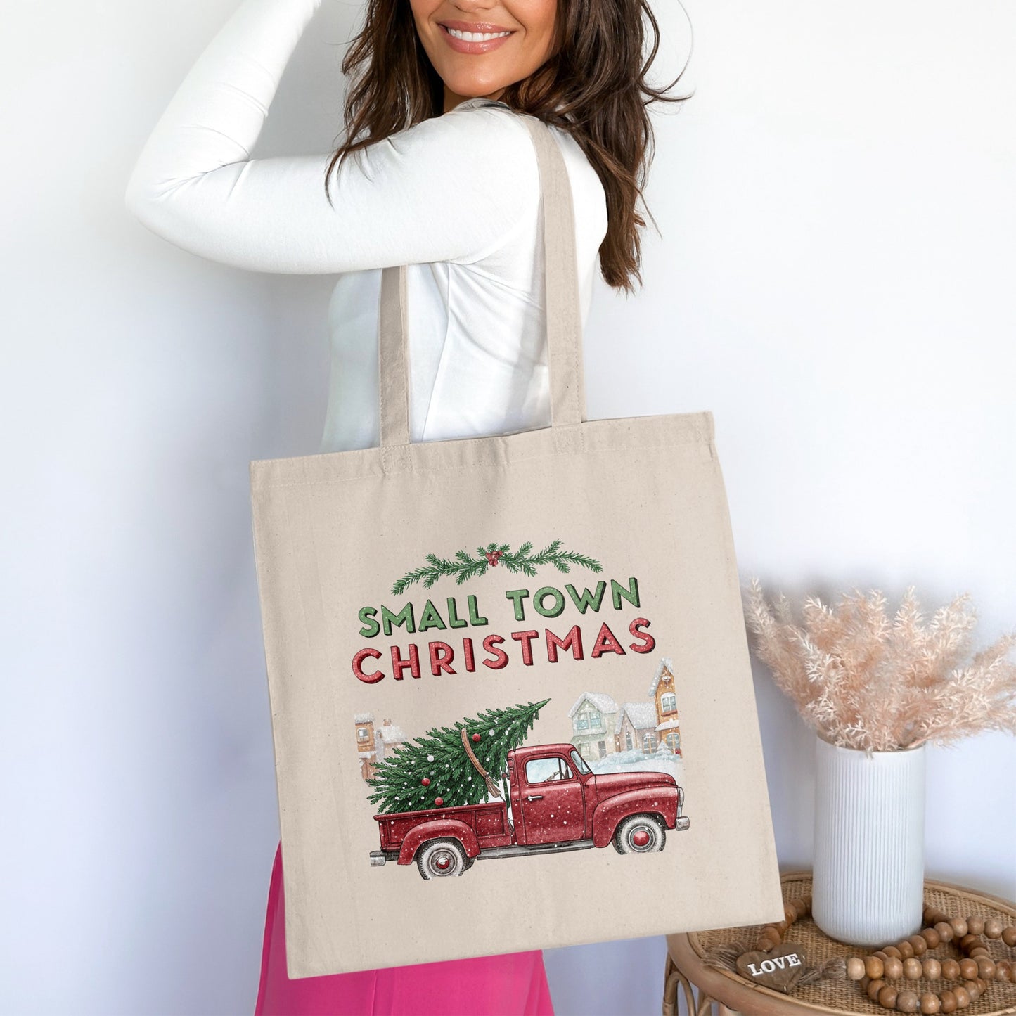 Canvas tote bag with "Small Town Christmas" text and red truck carrying a tree.