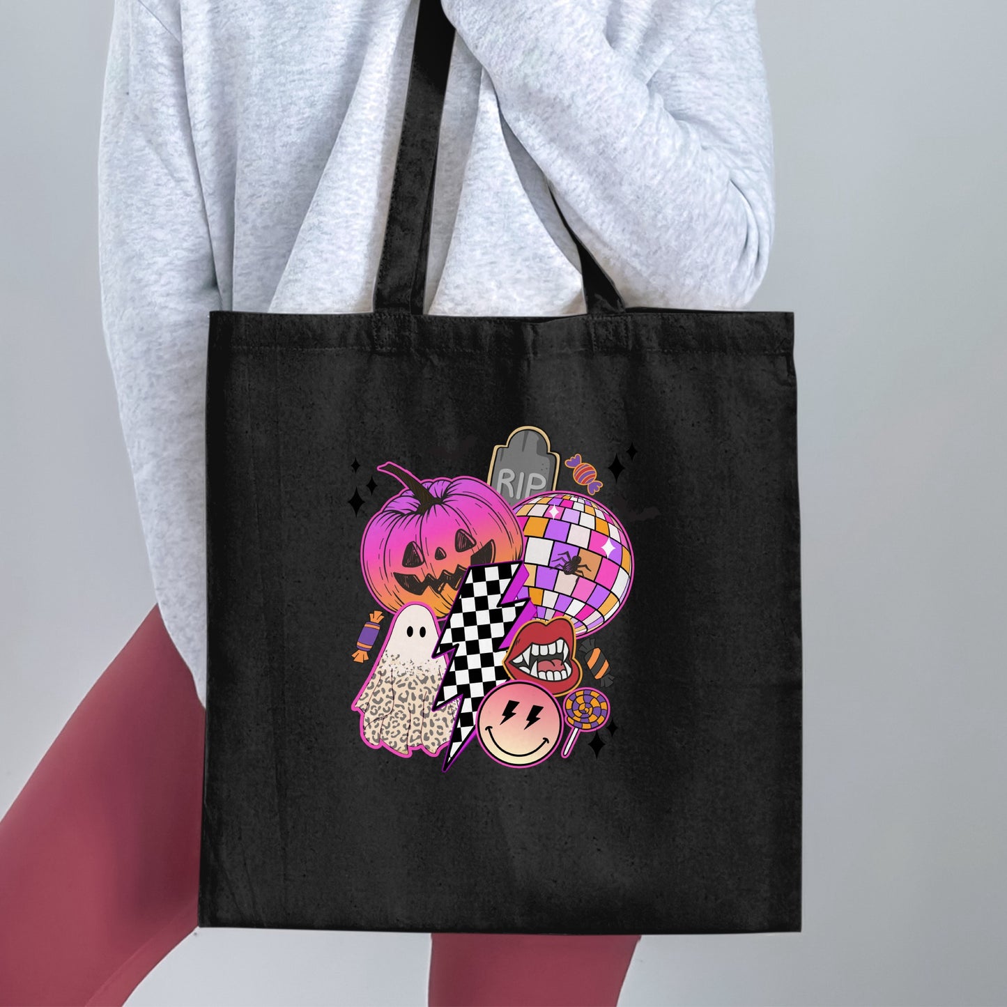 Black tote bag with Halloween-themed graphic featuring pumpkin, ghost, disco ball, and glittery accents.