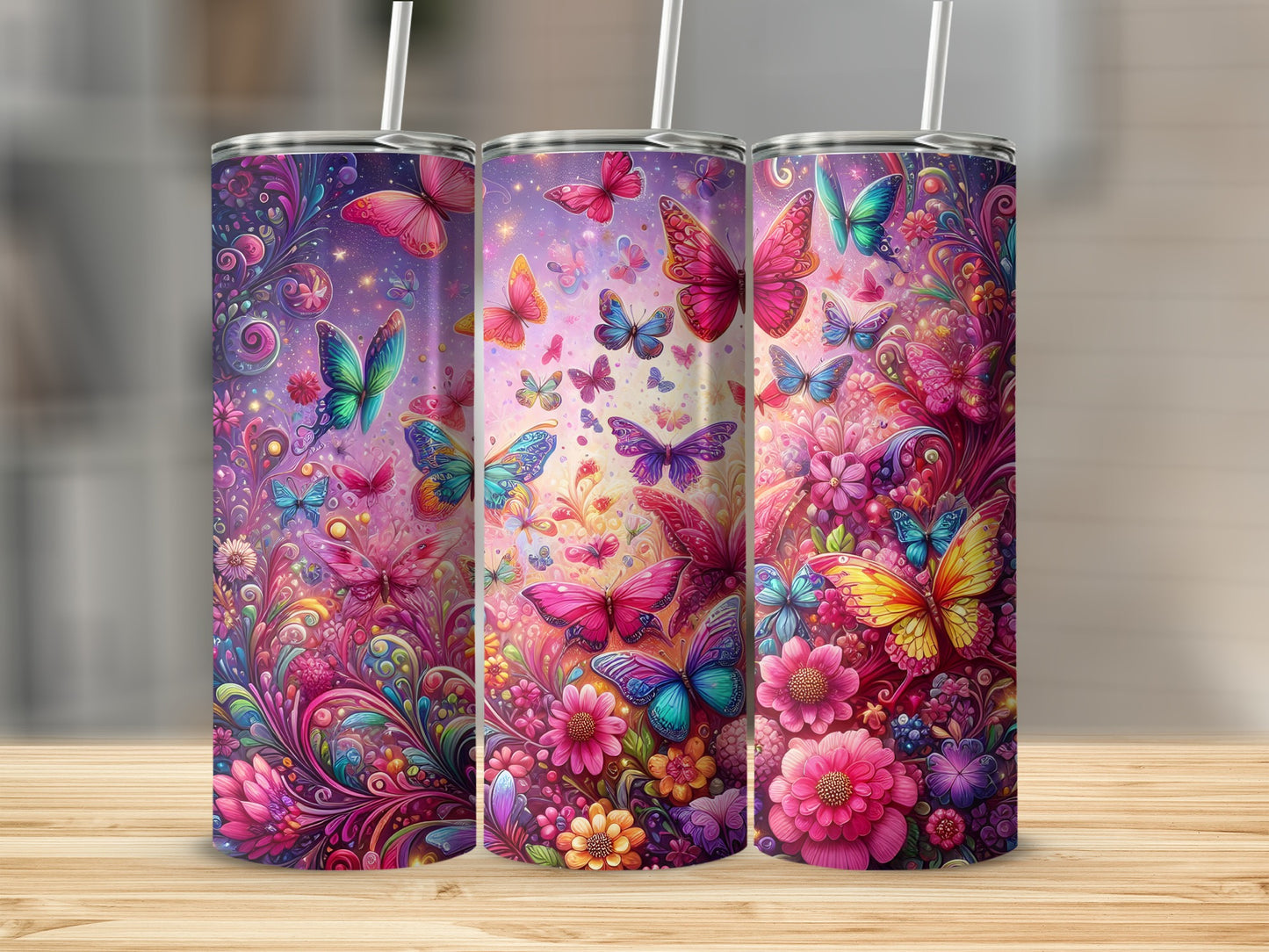 Three tumblers with colorful butterfly and floral designs.
