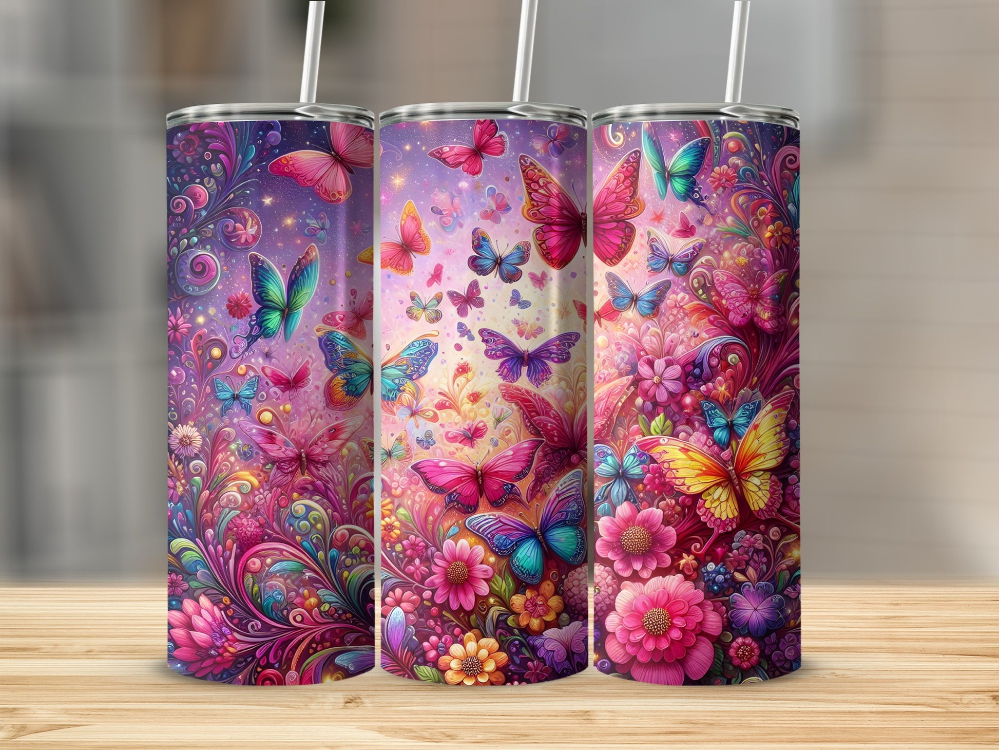 Three tumblers with colorful butterfly and floral designs.