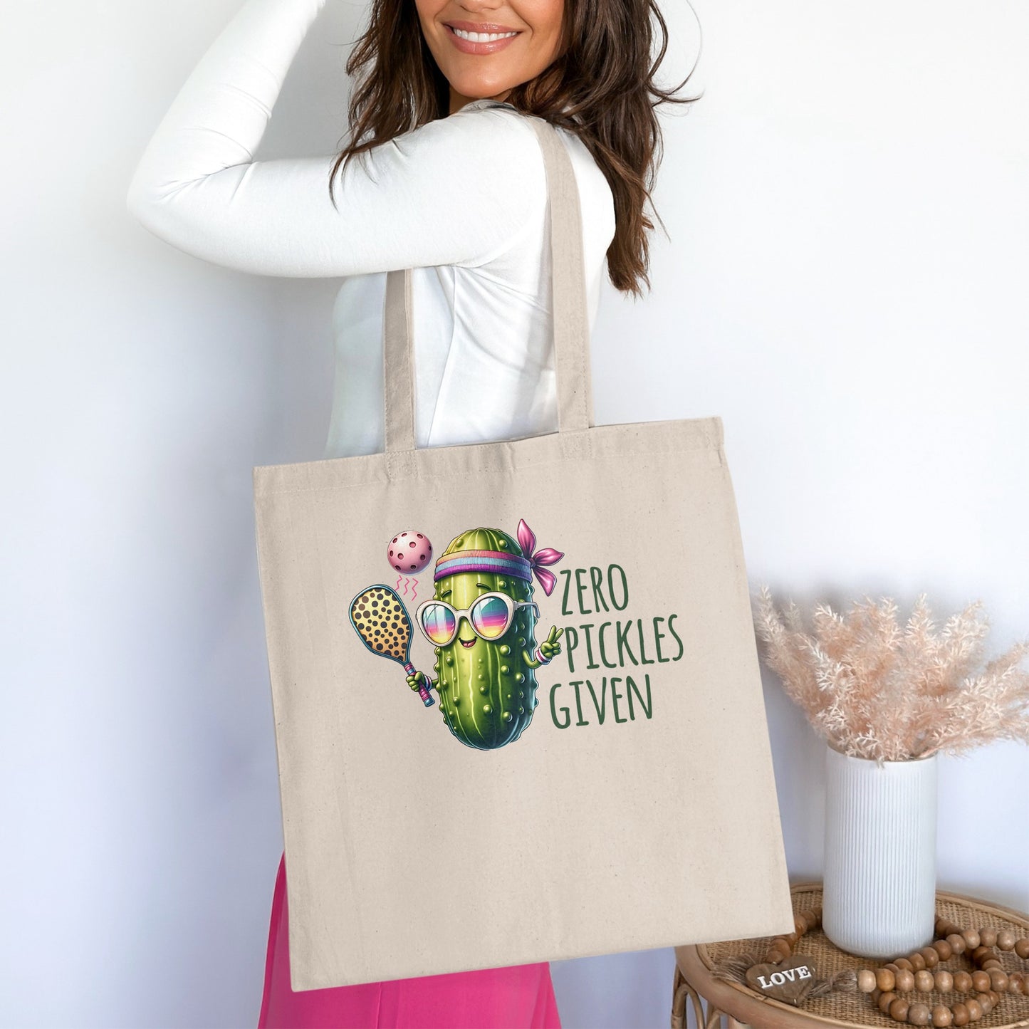 Tote bag with cartoon pickle playing pickleball, text reads "Zero Pickles Given".