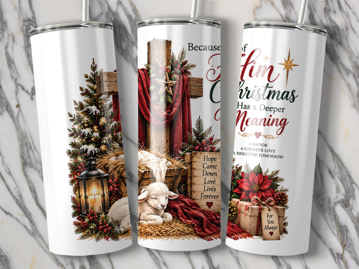 Three white tumblers display Christian Christmas artwork featuring a wooden cross, a manger, text, and festive decorations against a marble background.