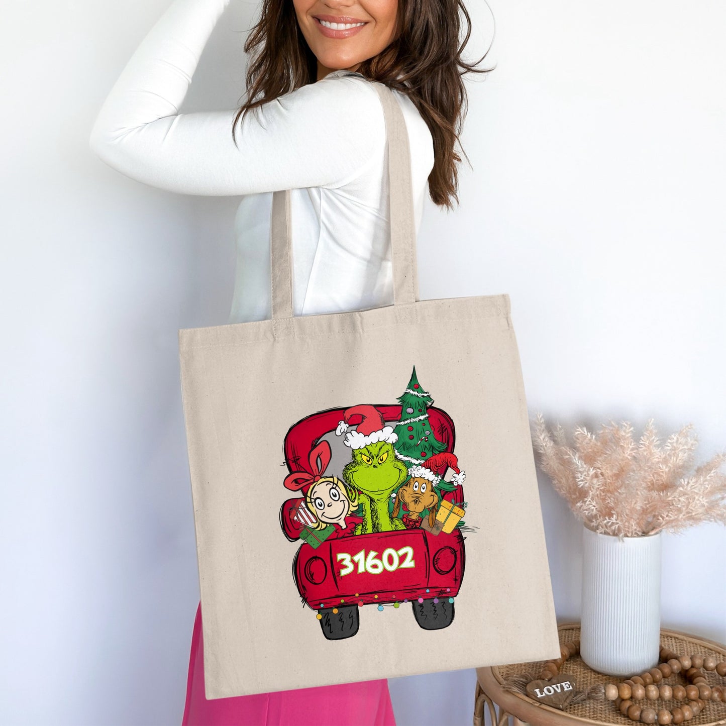 Tote bag with The Grinch, Cindy Lou Who, and Max in a red truck, displaying "31602".