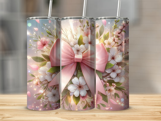 Pink floral bow design on three tumblers with white straws.
