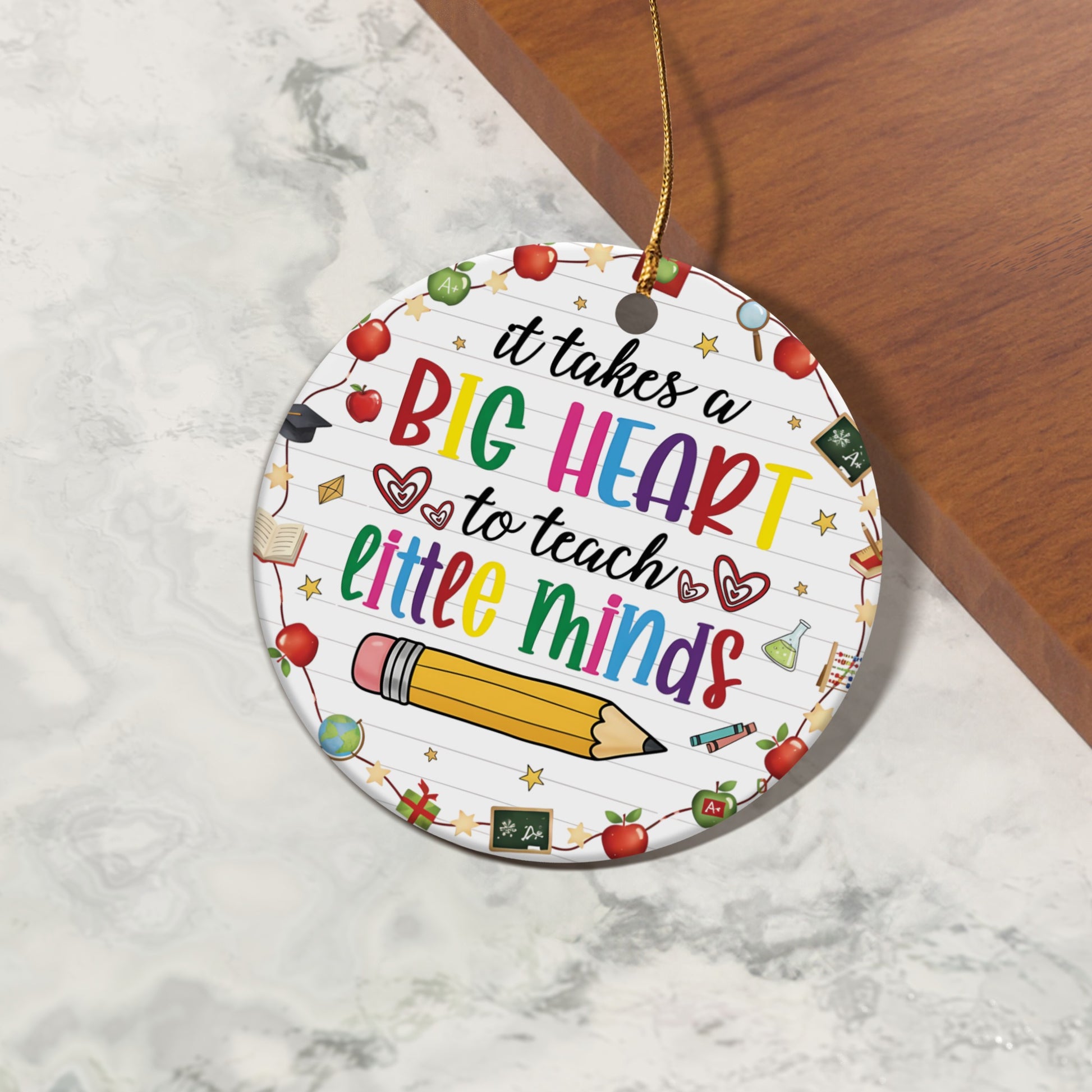 Round ornament with "It takes a BIG HEART to teach little minds" and school icons.
