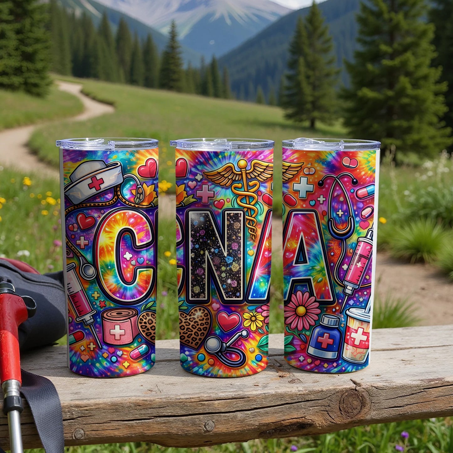 Three CNA tumblers with colorful tie-dye patterns and medical icons.