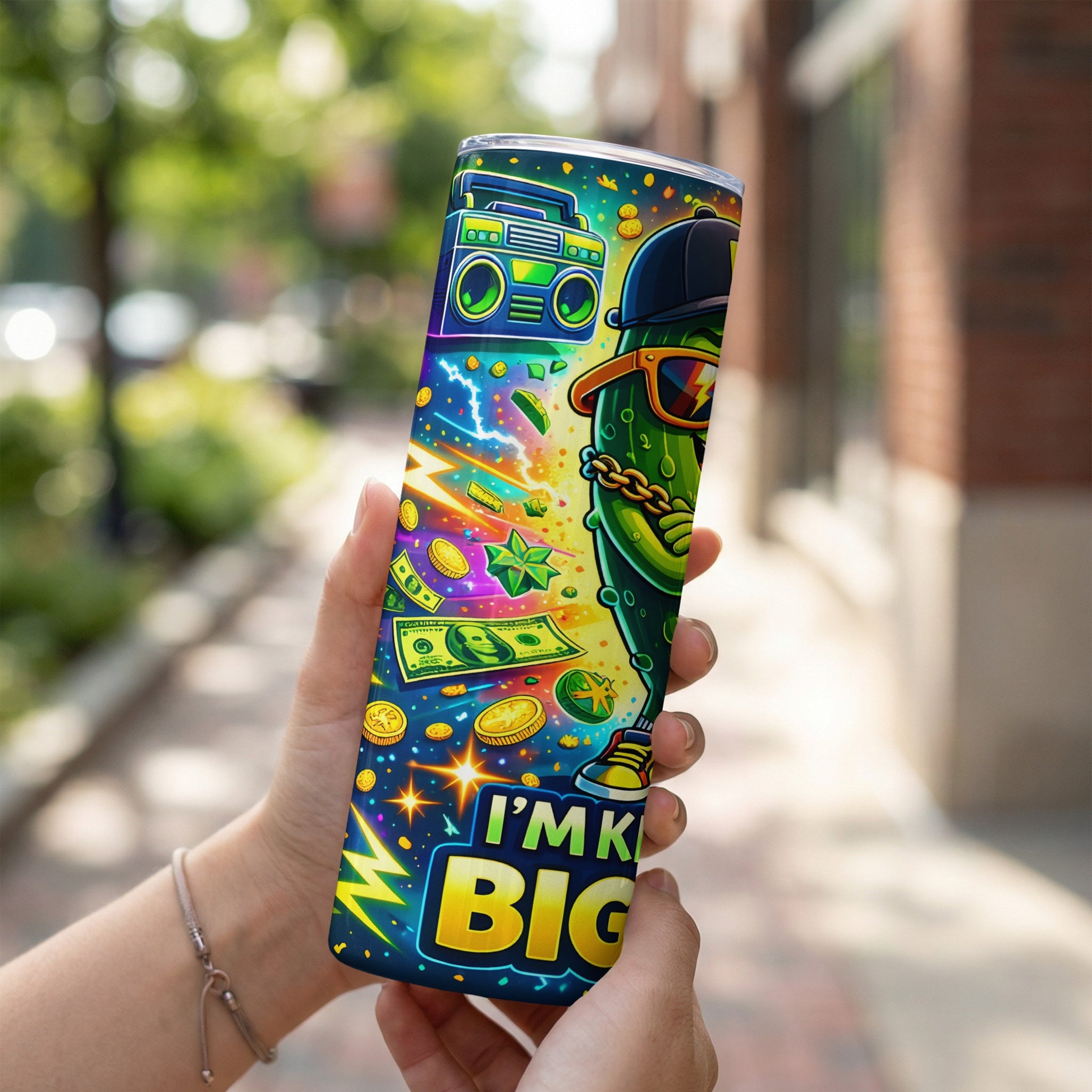 Tumbler with a cartoon pickle wearing sunglasses and money graphics.