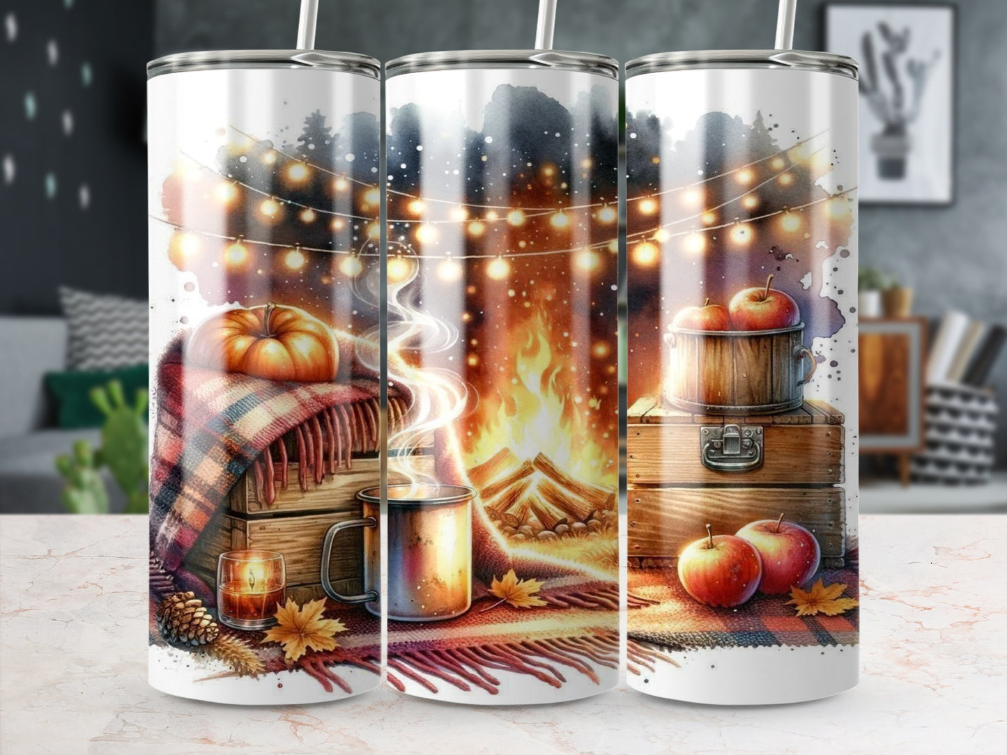 Tumbler with cozy autumn scene: pumpkin, fireplace, apples, and string lights.