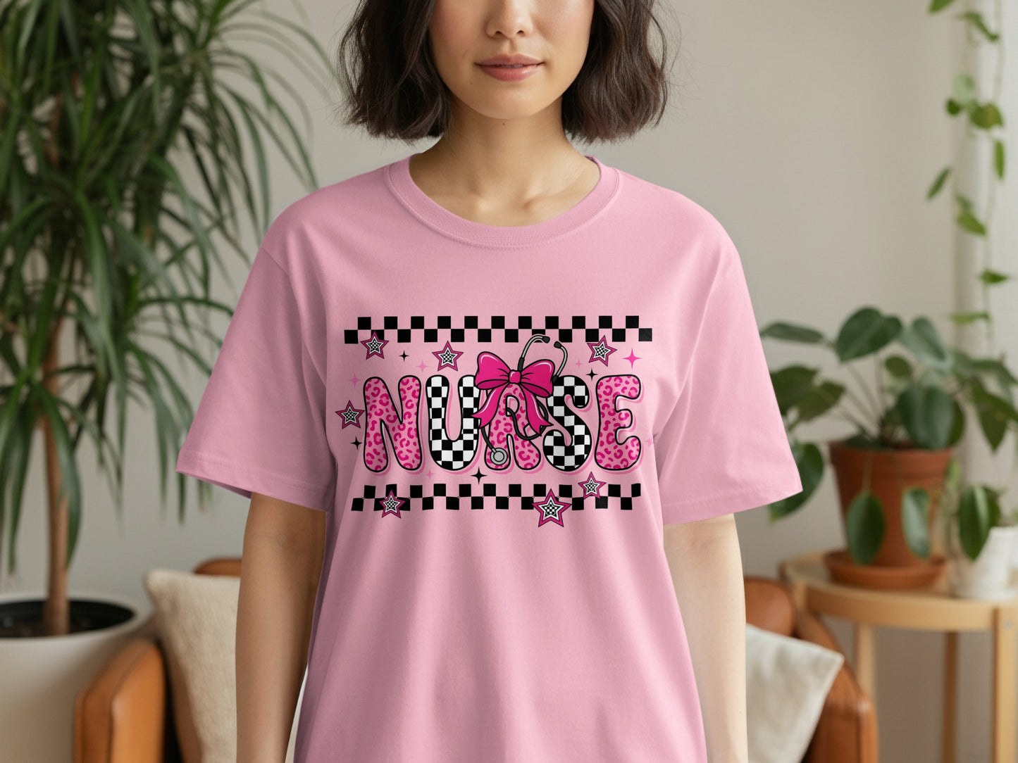 Pink t-shirt with "NURSE" in large letters and stethoscope graphic.