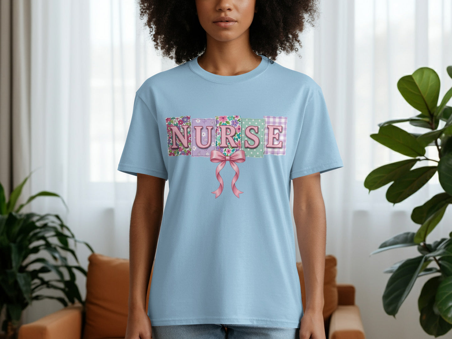 Light blue t-shirt with "NURSE" spelled out in patchwork fabric squares and a pink bow.