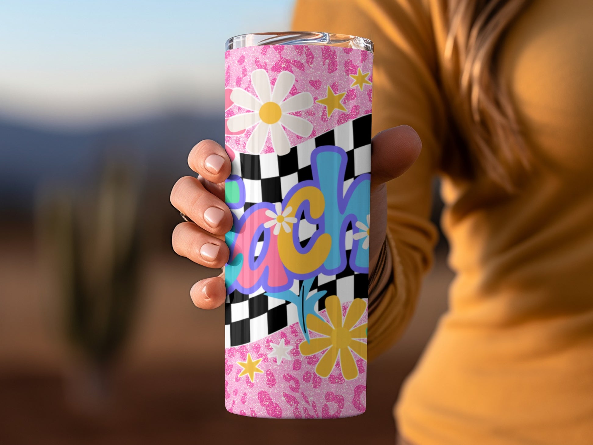 Tumbler with pink glitter, leopard print, daisies, stars, and checkered pattern.