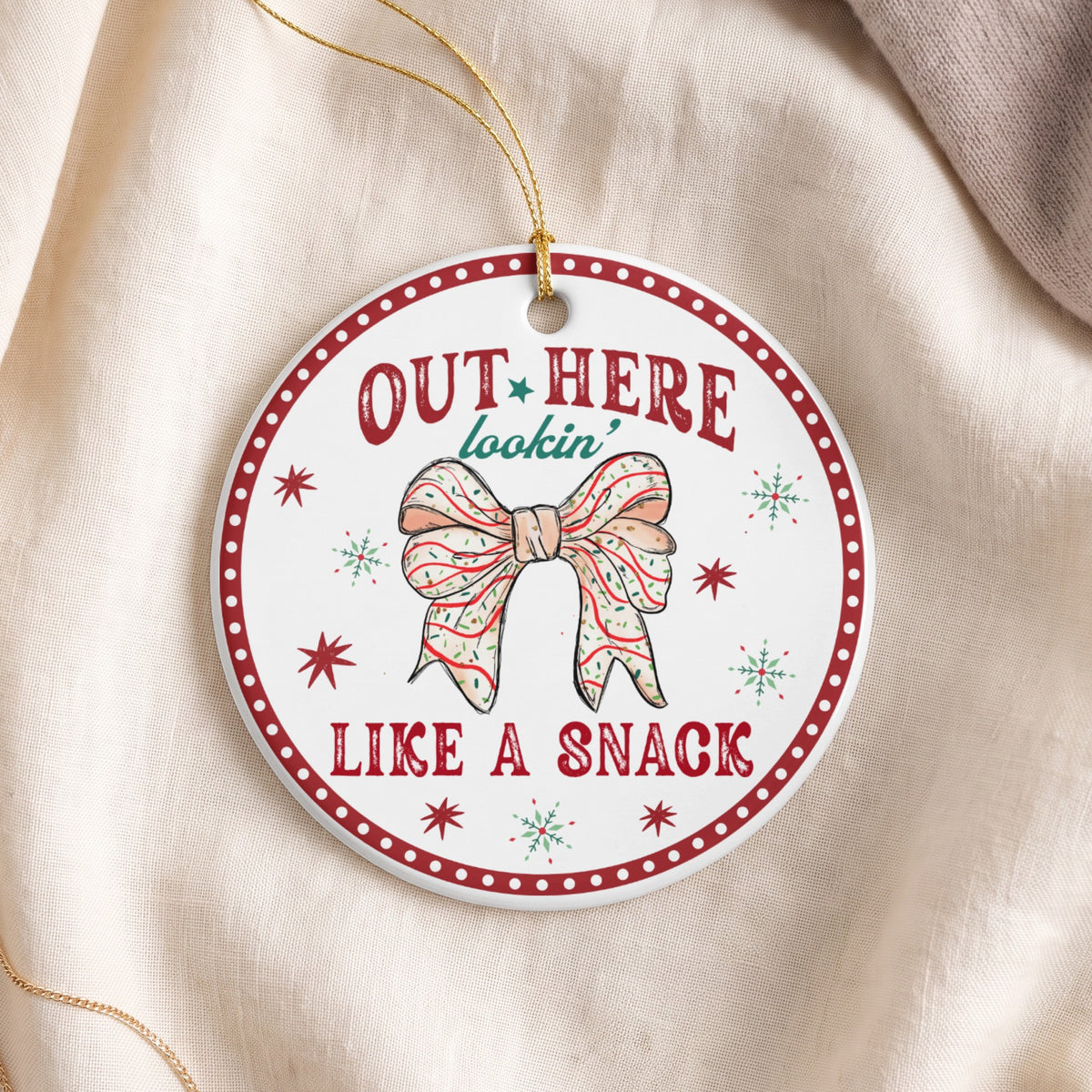 Round ornament with red and white border, saying "OUT HERE lookin' LIKE A SNACK".