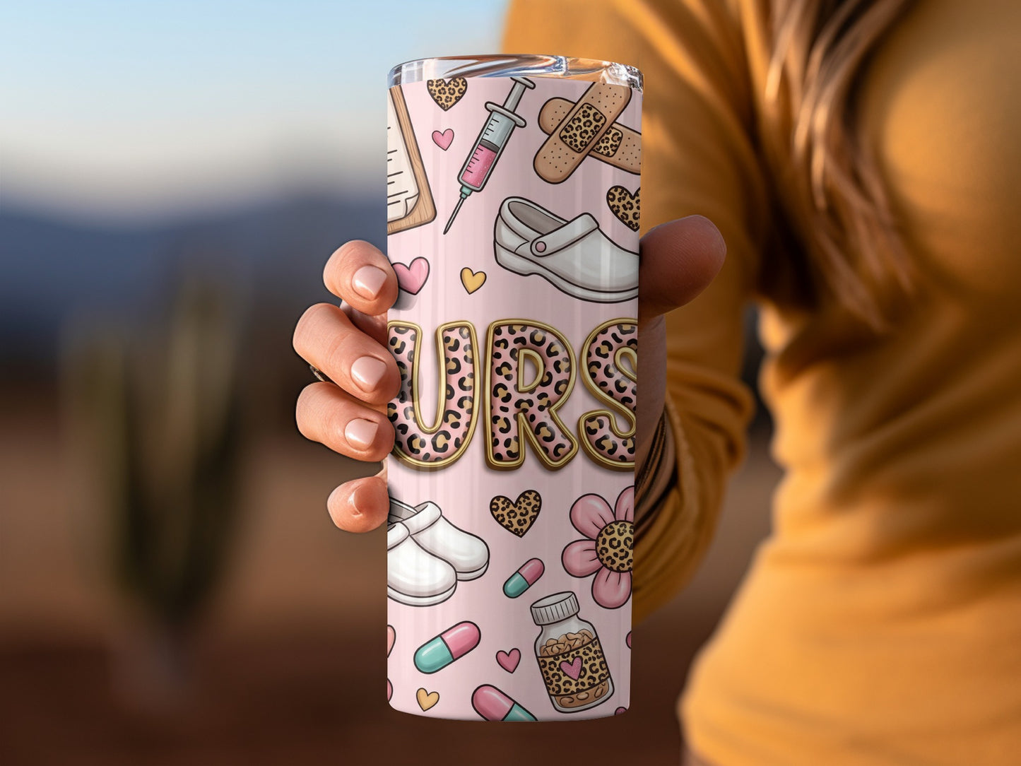 Tumbler with "NURSE" text, medical symbols, and pink floral accents.