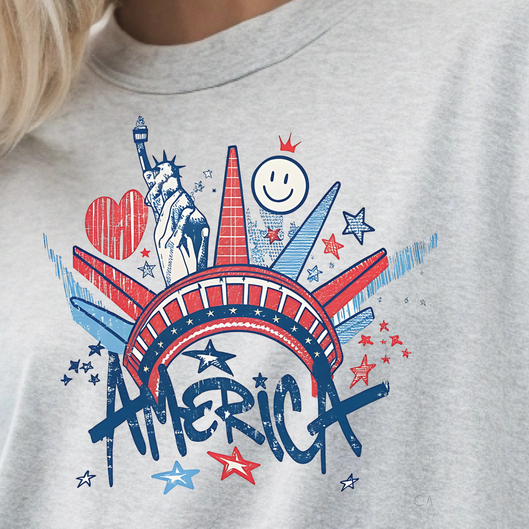 Gray t-shirt with a colorful 'AMERICA' graphic design featuring the Statue of Liberty and Smiley Face.