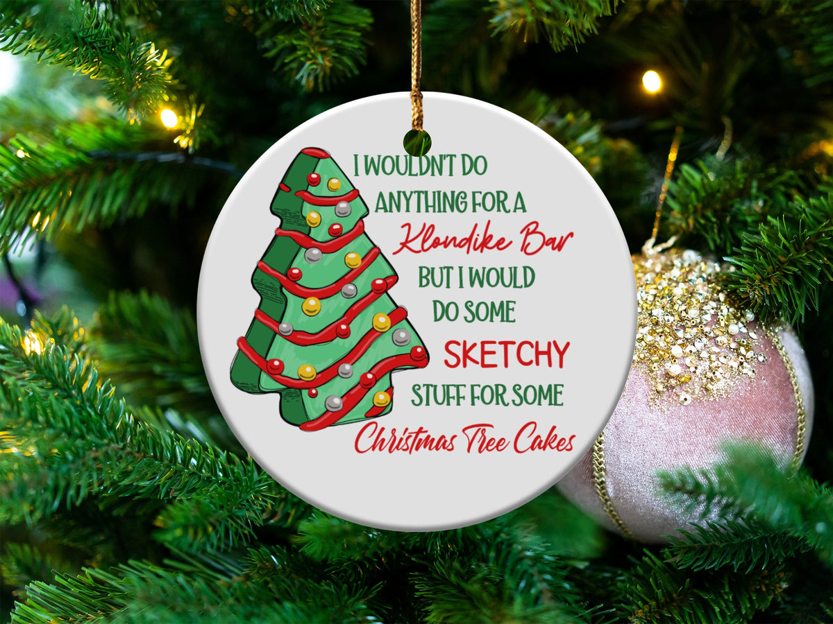 Christmas ornament with a tree illustration and text "I wouldn't do anything for a Klondike Bar but I would do some sketchy stuff for some Christmas Tree Cakes".