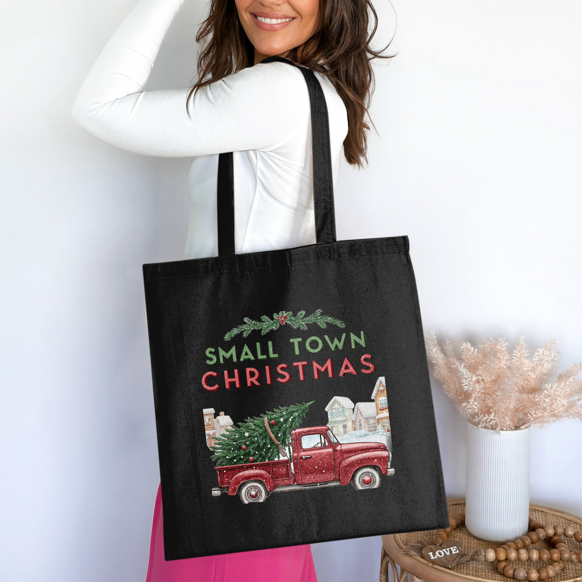 Black tote bag with "Small Town Christmas" text, red truck, and Christmas tree design.