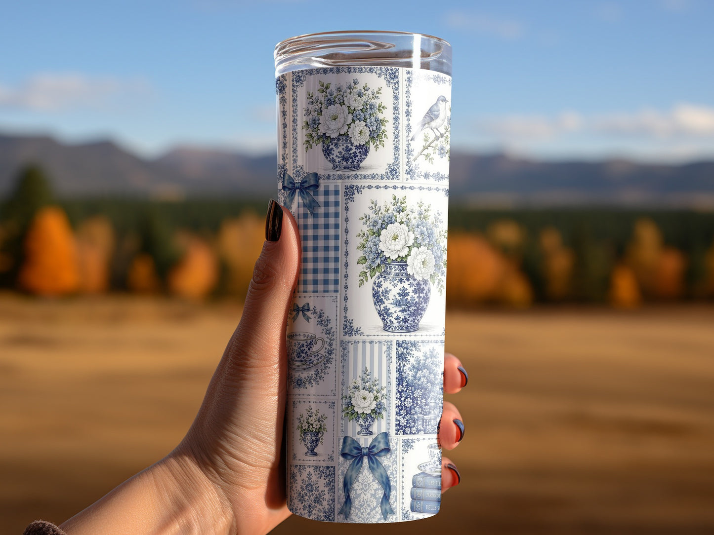 Tumbler with blue and white Chinoiserie pattern featuring floral vases and a bird.